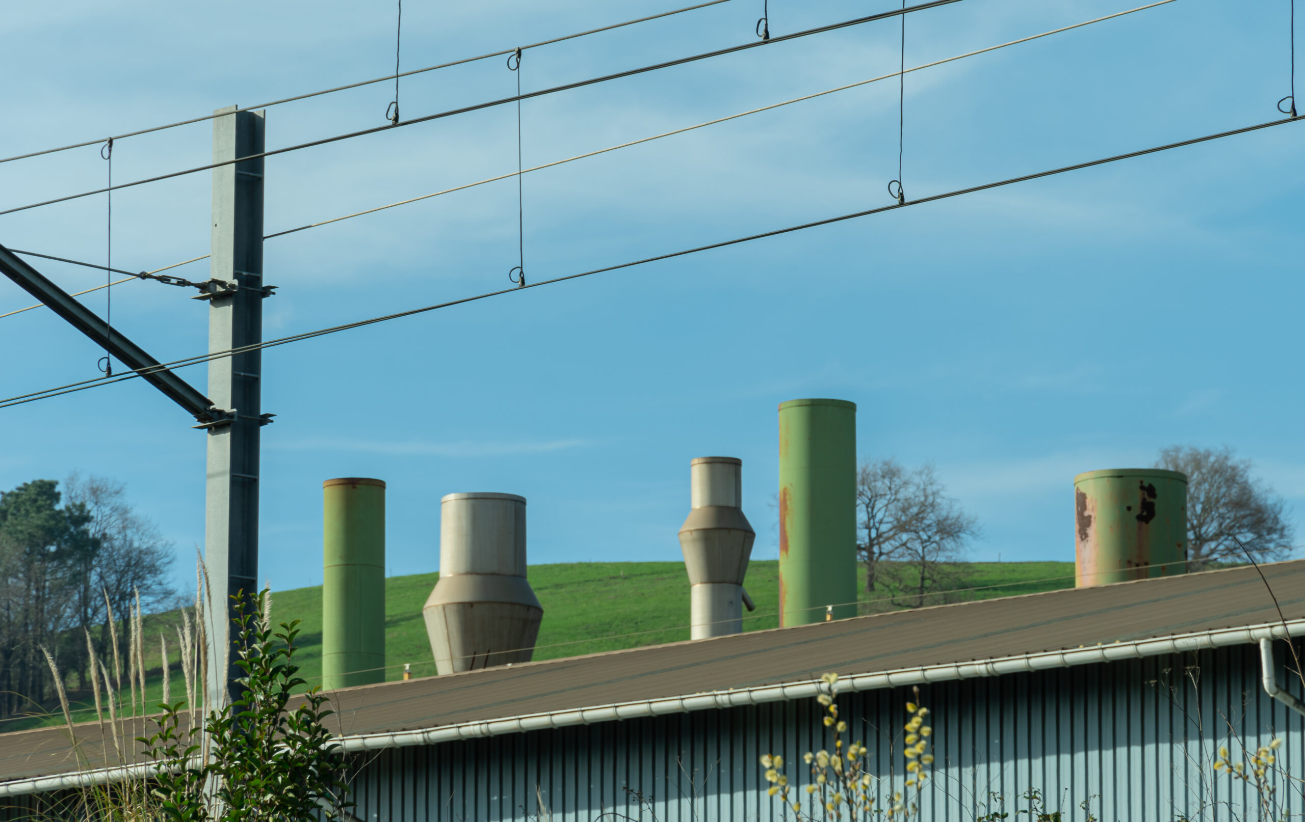 Industrial buildings framed by the green hills of Lasarte, Basque Country, Spain.