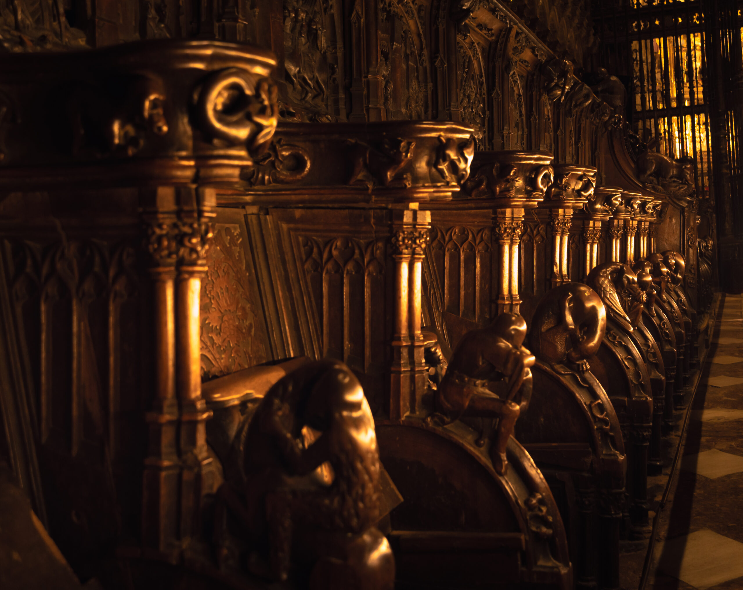 Intricately carved wooden choir stalls inside Segovia Cathedral, Spain.