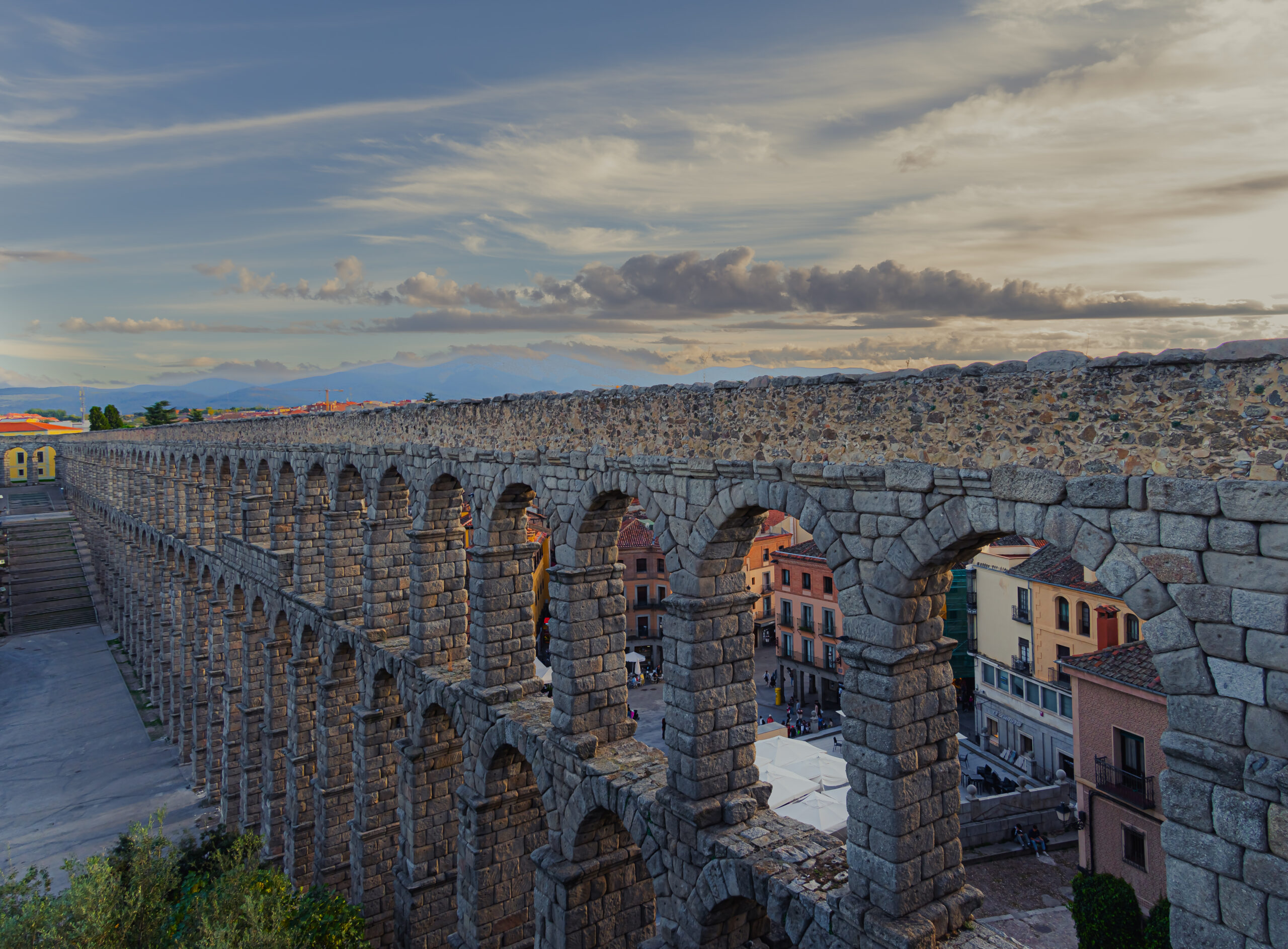The Roman Aqueduct of Segovia stretching across the historic city center, Spain.