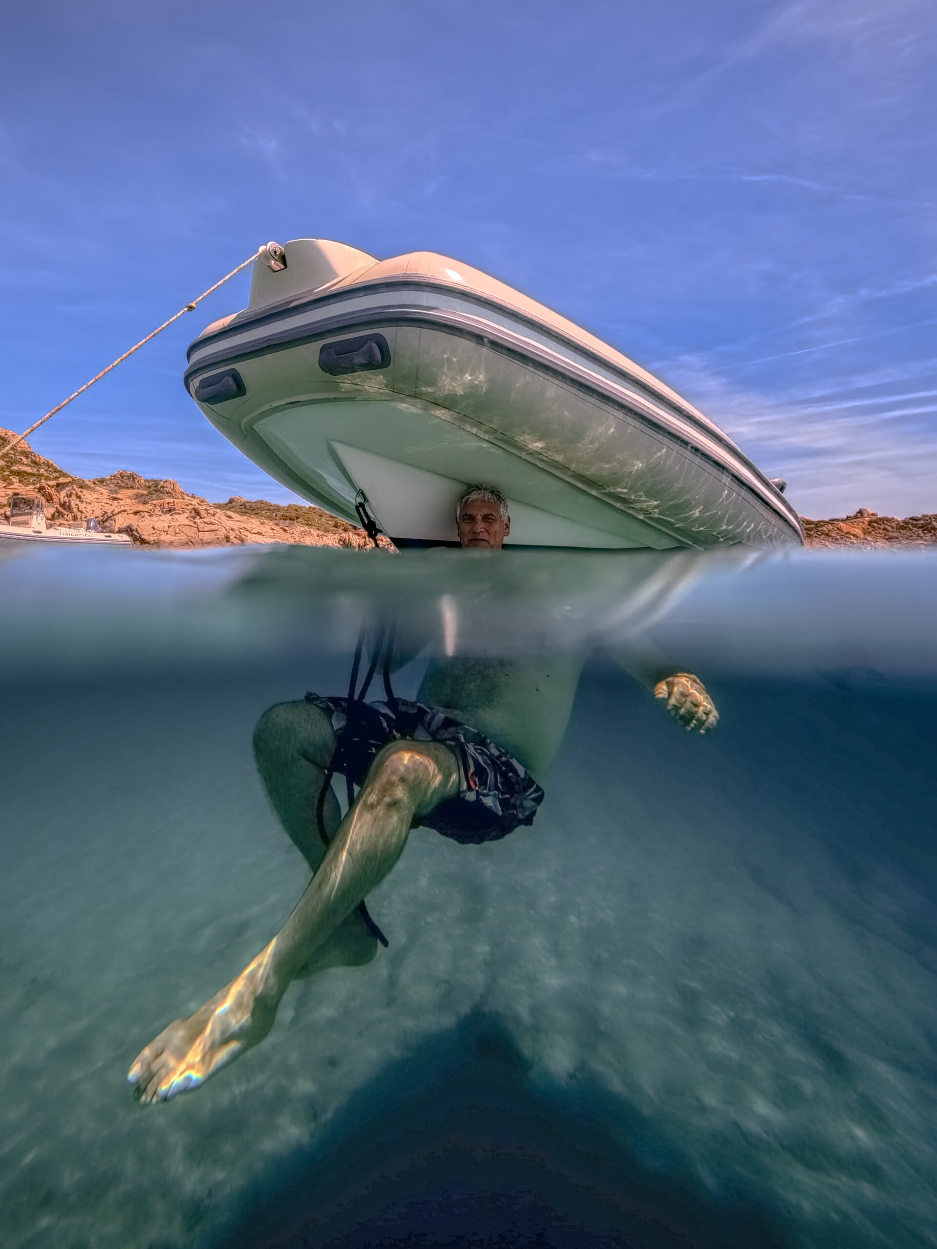 Underwater view distorted by the refraction of light in the clear waters of La Maddalena, Sardinia.