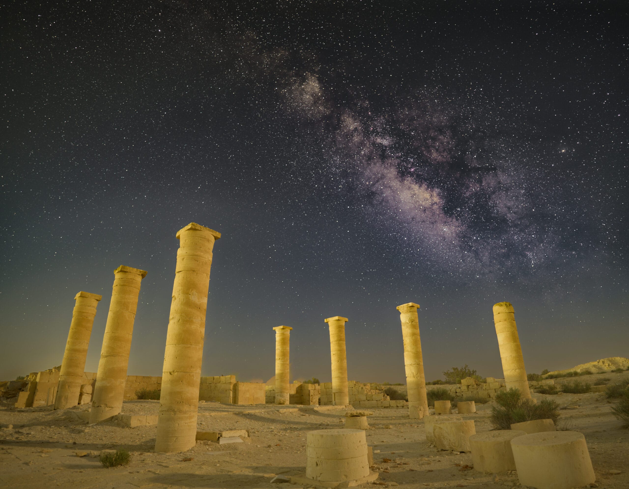 The Milky Way rising above the ancient stone columns of Nitzana in the Negev Desert, Israel.