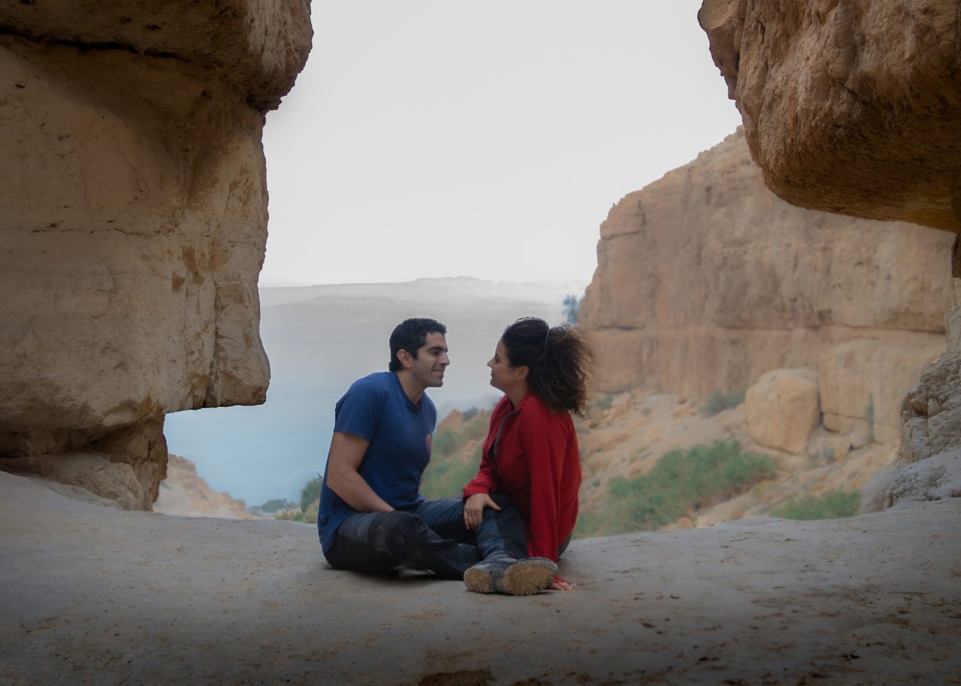 Two people overlooking the Dead Sea from Ein Gedi Nature Reserve, Israel.