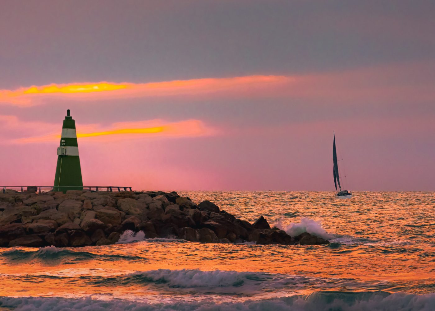 Lighthouse at Tel Aviv Marina during sunset on the Mediterranean coast, Israel.
